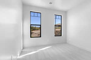 Carpeted empty room with baseboards