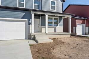 **DISCLAIMER, exterior and interior option may vary**Doorway to property featuring a porch and concrete driveway