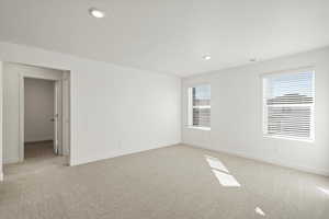 Unfurnished room featuring light colored carpet, recessed lighting, and a textured ceiling