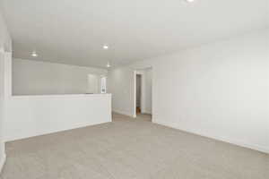Unfurnished room with light carpet and recessed lighting