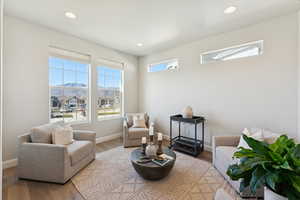 Sitting room featuring wood finished floors, a mountain view, and recessed lighting
