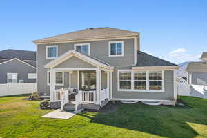 Rear view of property with a fenced backyard, roof with shingles, a deck, and a gate