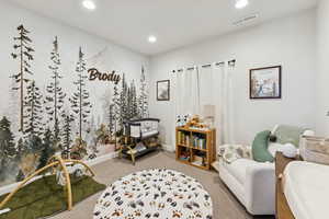 Sitting room with carpet floors and recessed lighting