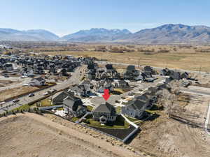 Aerial overview of property's location with nearby suburban area and a mountain backdrop