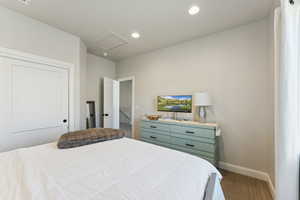 Carpeted bedroom with recessed lighting, attic access, and a closet