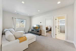 Living room with carpet flooring and recessed lighting