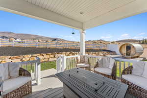 Deck with a fenced backyard, a mountain view, and an outdoor living space