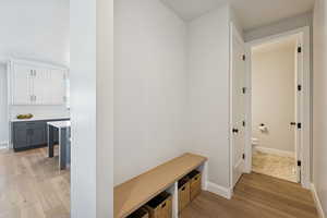 Mudroom featuring light wood-type flooring and baseboards