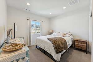 Carpeted bedroom with recessed lighting