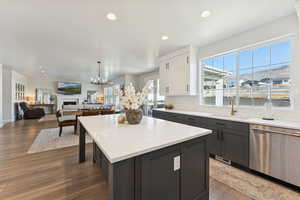 Kitchen featuring stainless steel dishwasher, recessed lighting, decorative backsplash, light wood-style floors, and open floor plan