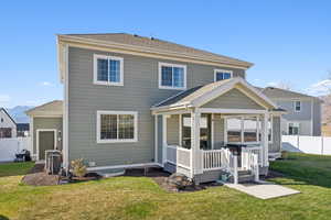 Back of house featuring a shingled roof and a deck with mountain view