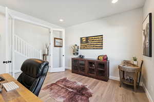 Office area with light wood-style flooring, recessed lighting, and french doors