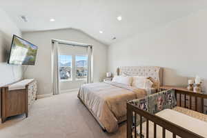 Bedroom with vaulted ceiling, carpet flooring, and recessed lighting
