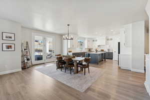 Dining area featuring a chandelier, light wood finished floors, and recessed lighting