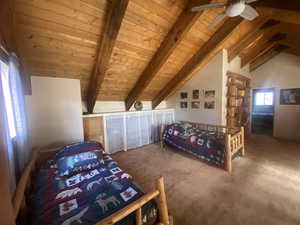 Bedroom featuring carpet floors, wood ceiling, and a ceiling fan