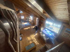 Bedroom with wood-type flooring, wood walls, and wood ceiling