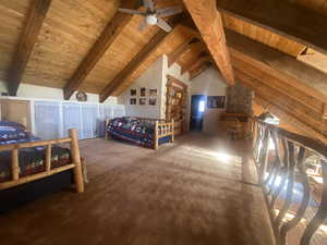 Bedroom featuring wood ceiling, carpet floors, and ceiling fan