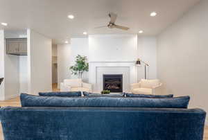 Living area with recessed lighting, light wood-style flooring, a fireplace, and a ceiling fan