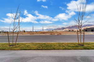 View of asphalt street featuring a mountain view