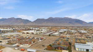 View of mountain backdrop featuring an industrial area