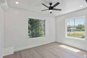Empty room featuring light wood-style flooring, recessed lighting, and a ceiling fan