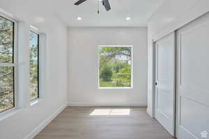 Unfurnished bedroom featuring a closet, light wood-type flooring, recessed lighting, and a ceiling fan