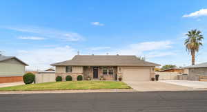 Single story home featuring concrete driveway, a garage, brick siding, and a shingled roof