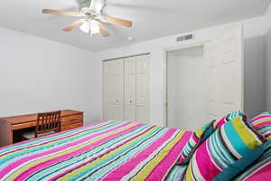 Bedroom with a closet and ceiling fan
