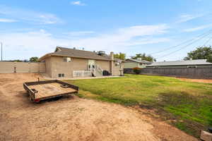 Back of house featuring a wooden deck, a fenced backyard, a patio, stucco siding, and a gate