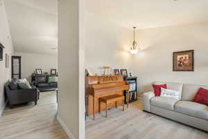 Living area featuring light wood-type flooring and lofted ceiling