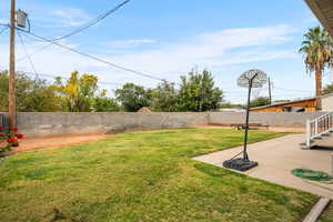 Fenced backyard featuring a patio