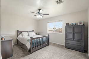 Bedroom with light colored carpet and ceiling fan