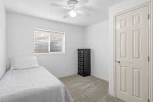 Bedroom with light colored carpet and ceiling fan