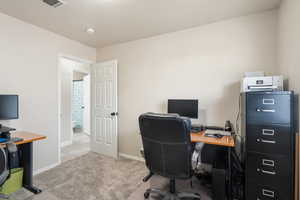 Office featuring light carpet and baseboards