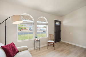 Sitting room featuring light wood-type flooring and baseboards