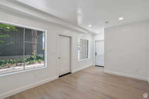 Foyer entrance featuring light wood finished floors and recessed lighting