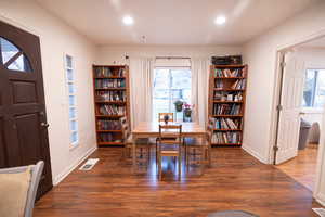 Dining room with wood finished floors and recessed lighting