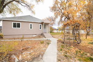 View of side of property featuring roof with shingles