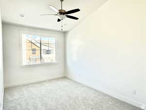 Empty room with carpet flooring, ceiling fan, recessed lighting, and vaulted ceiling