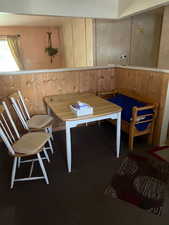 Dining room with wood walls and wainscoting