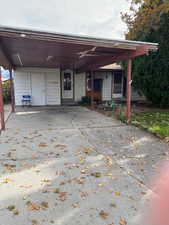 View of front facade with an attached carport and driveway