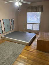Bedroom featuring light wood-type flooring and a ceiling fan