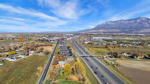 Aerial overview of property's location with a major roadway and a mountainous background
