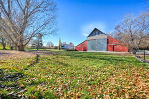 View of yard featuring an outdoor structure and a pole building