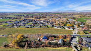 Aerial view of property and surrounding area with nearby suburban area and a mountainous background
