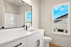 Bathroom featuring vanity, light wood-style flooring, and a shower