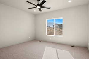 Carpeted spare room with recessed lighting and a ceiling fan