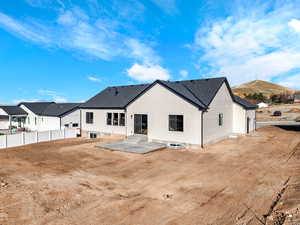 Rear view of property with a patio, a shingled roof, entry steps, and a mountain view