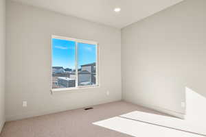 Carpeted empty room with baseboards and recessed lighting