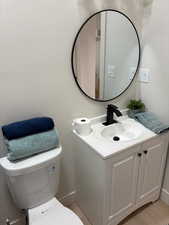 Half bathroom with vanity and baseboards